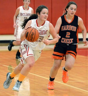 General McLane High School senior guard Celeste Seidel, left, dribbles ahead of Harbor Creek sophomore Ryleigh Oldach during second-half action in Washington Township on Dec. 6. GREG WOHLFORD/