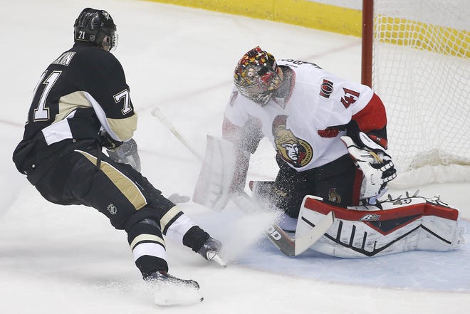Pittsburgh Penguins' Evgeni Malkin (71) scores a goal past Ottawa Senators goalie Craig Anderson (41) during the first period of an NHL hockey game in Pittsburgh Saturday, Dec. 6, 2014.(AP Photo/Gene J. Puskar