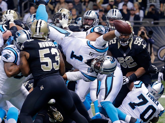 Carolina quarterback Cam Newton (1) dives over the pile for a touchdown in the first half against New Orleans on Sunday.