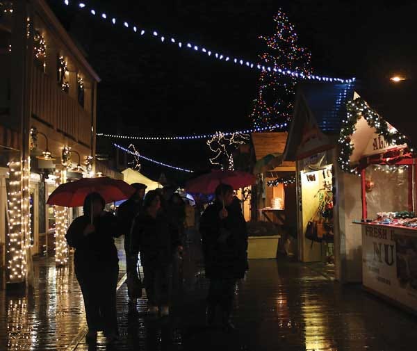 Photo by Marie Dirle/New Jersey Herald Festive lights and umbrellas adorn the Lake Mohawk boardwalk Saturday during the German Christmas market.