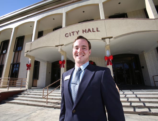 Ryan Kirby, the public communication coordinator for the City of Ocala, poses at Ocala City Hall in Ocala, Fla. on Thursday, Dec. 4, 2014. Kirby has been working for the city for 7 months.