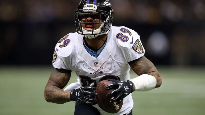 Veteran Ravens receiver Steve Smith, above, irritates many NFL defensive backs, but Miami’s Cortland Finnegan says he enjoys Smith’s approach. (Chris Graythen/Getty Images)