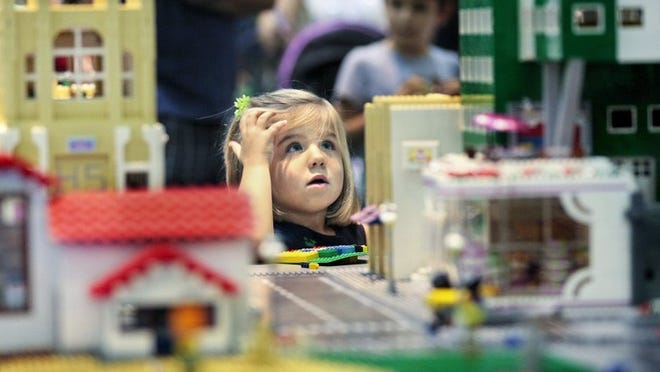 Elizabeth Rodriguez, 3, of Wellington takes in the massive Insperation Station Friendship Falls cityscape during Brick Fest on Dec 5, 2014, in West Palm Beach. Children were encouraged to add their own creations to the set provided by organizers. Chad Collins, founder of the event expects to have over five thousand visitors to the weekend event. Families from as far as Miami attended today’s afternoon session.