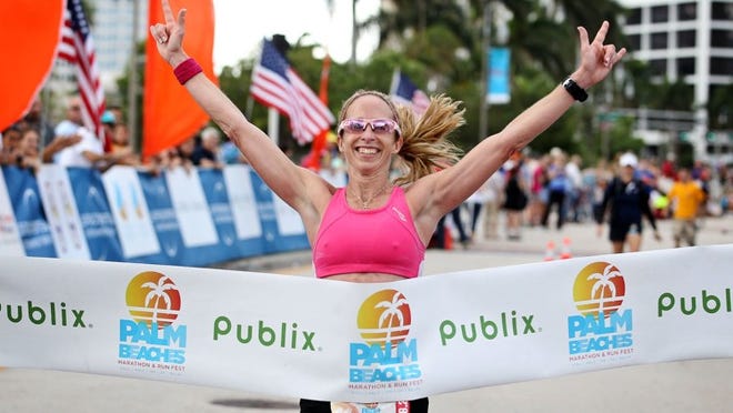 Jennifer Sober of Deep Creek Lake, Md., crosses the finish line in downtown West Palm Beach in the 2013 marathon. She said she was careful about adjusting for the warm temperatures and will do so again Sunday. (Richard Graulich/The Palm Beach Post)