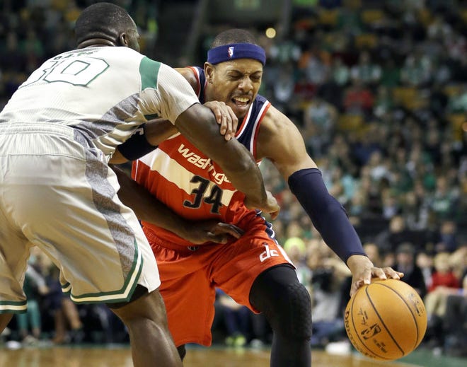 Wizards forward Paul Pierce looks for an opening around Brandon Bass Sunday afternoon at the TD Garden. AP