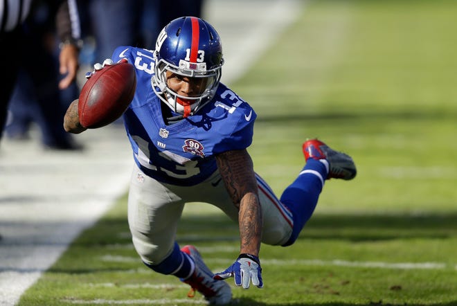 Giants wide receiver Odell Beckham Jr. reaches for extra yardage Sunday during the first half of a game against the Tennessee Titans in Nashville, Tenn. Beckham caught 11 passes for 130 yards and a touchdown in the Giants' 36-7 win. THE ASSOCIATED PRESS