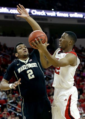 N.C. State guard Ralston Turner, right, goes up against Wake Forest's Devin Thomas on Saturday night.