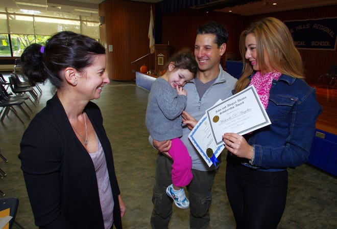 Bethann D'Angelico of Canton, along with husband Mike and daughter Michaela, a senior at Blue Hills Technical School, enjoy Michaela's Adams Scholarship award. It even got a smile from Michaela normally very shy 2-year-old younger sister, Sofia.

Wicked Local photo/Mark Jarret Chavous