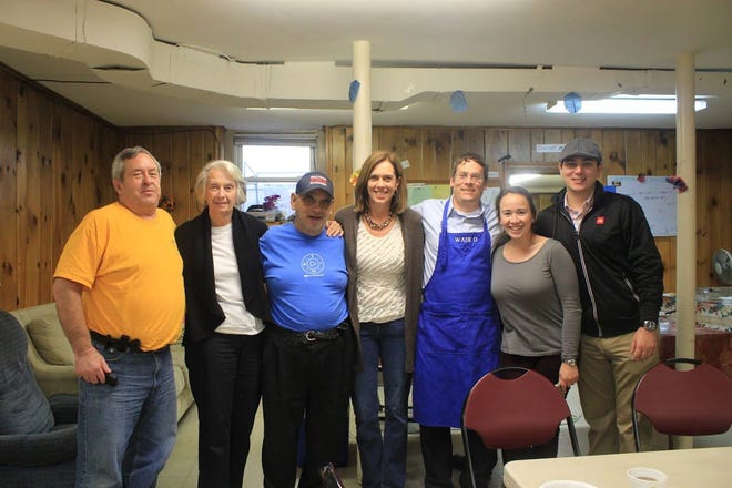 U.S. Rep. Katherine Clark, center, with the help of fellow volunteers including Councilor Bill Fowler, far left, served Thanksgiving dinner to Community Day Center guests. COURTESY PHOTO