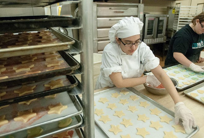 Alexis Decker, a senior at the Bucks County Technical High School from Morrisville, decorates cookies during her Baking and Pastry Arts program class at the Bucks County Technical High School on Thursday afternoon.
