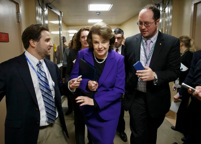 Senate Intelligence Committee Chair Sen. Dianne Feinstein, D-Calif. is pursued by reporters on Capitol Hill in Washington, Tuesday, Dec. 9, 2014, as she arrives to release a report on the CIA's harsh interrogation techniques at secret overseas facilities after the 9/11 terror attacks. (AP Photo/J. Scott Applewhite)