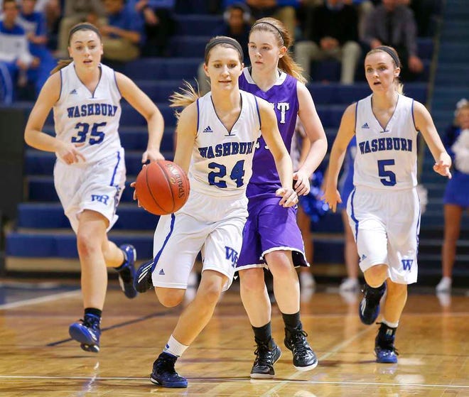 Washburn Rural's Lauren Biggs, center, dribbles down the court past Topeka West's Addison Donohue, back center, after stealing a ball during the first half of Tuesday night's game at Washburn Rural.