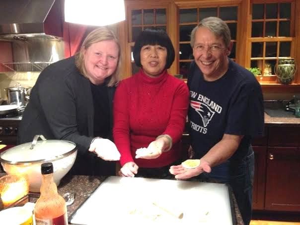 Masconomet High School Principal Laurie Hodgdon, Zhang (Julie) Juli and Superintendent Kevin Lyons make dumplings together at Lyon's home before watching the New England Patriots game. Courtesy Photo