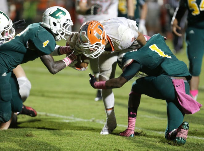 DeLand's Tomas Ward, right, tries to bring down University's Jeremy Diaz on Oct. 3, The two will take part in the Central Florida All-Star game Thursday night.