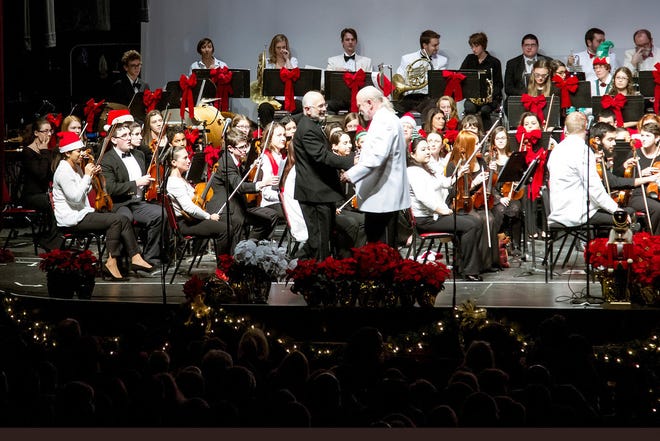 Toby Monte, New Bedford Youth Symphony Orchestra conductor, left, shakes hands with David MacKenzie, New Bedford Symphony Orchestra conductor, at last year's Family Holiday Pops Concert. The Youth Orchestra students sit on stage alongside the NBSO musicians.