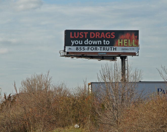 A billboard with the message "Lust Will Drag You Down to Hell" is posted on Route 195 just before the East Providence exit.