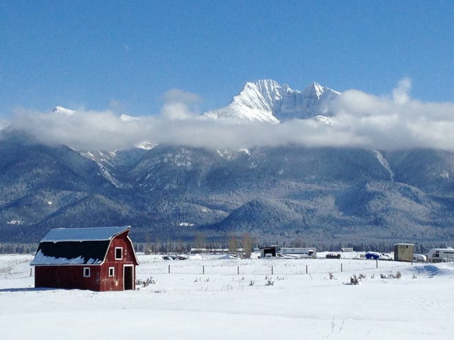 A Montana mountain and barn in sunshine.