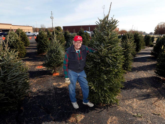 James Neville stands at the Tuscaloosa YMCA Men's Club Christmas tree sale in the former Bruno's grocery store parking lot on McFarland Boulevard Wednesday, Dec. 10, 2014. This is Neville's 50th year working the sale.