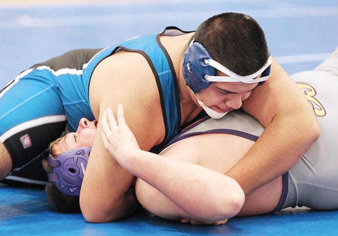 Adrian junior Thomas Soto (top) pins Blissfield’s Jack VanBuren during a 215-pound match in Wednesday’s quad meet at Adrian High School. The Maples defeated Blissfield 42-24 in their dual. Both Adrian and the Royals finished the night 1-1, with Adrian falling to Dundee and Blissfield beating Quincy. Telegram photo by John Discher