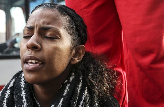 In a Tuesday, Nov. 25, 2014 file photo, Eilidh Branson, a student at Spelman College, sings along with a group of protestors at a rally and protest at the CNN Center, in Atlanta, the day after a grand jury's decision not to indict a white Ferguson, Mo., police officer who killed Michael Brown, an unarmed black teen. Protest songs are taking their place alongside the chants of “I Can’t Breathe” and “Hands Up, Don’t Shoot” as demonstrators raise their voices to condemn the deaths of unarmed black men at the hands of police. (AP Photo/Ron Harris, File)