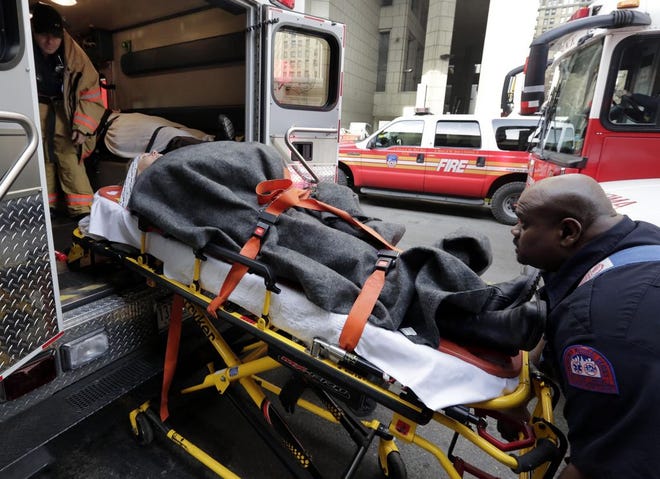 In this Jan. 9, 2013 file photo, an injured passenger of a New Jersey ferry is loaded into an ambulance, in New York. Nearly 20 percent of U.S. consumers _42.9 million people _ have unpaid medical debts, according to a new report released Thursday, Dec. 11, 2014 by the Consumer Financial Protection Bureau. The findings suggest that many Americans lack the financial resources to pay for health emergencies _ and that the notices from hospitals and insurance companies about the cost of treatment are confusing and baffling. (AP Photo/Richard Drew, File)