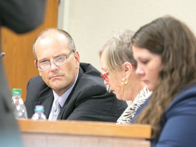In this Nov. 18, 2014 file photo, Richard Drake sits with his attorneys Tricia Jenkins, center, and Amanda Sizemore in his first second-degree murder trial at the Marion County Courthouse in Ocala. A new trial date has been set.