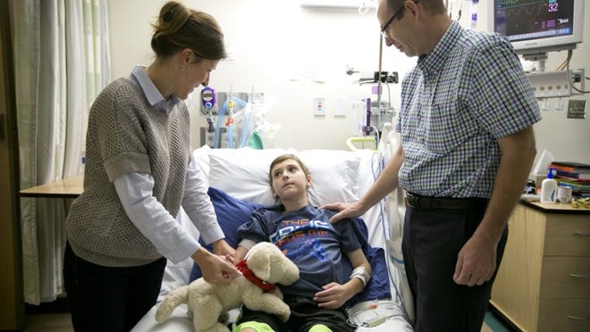 Jadwiga and Roger Hermann talk to their son, Alex, 9, after a speech therapy session at Dell Children’s Medical Center of Central Texas in October.