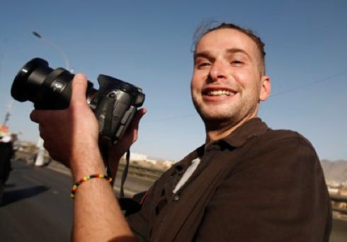 Luke Somers, 33, an American photojournalist who was kidnapped over a year ago by al-Qaida, poses for a picture during a parade In this Feb. 11, 2013 file photo, in Sanaa, Yemen. The American photojournalist was killed during a high risk raid to free him and a South African teacher from al-Qaida militants in Yemen.