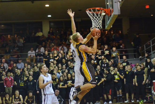 Senior forward Josh Hart from Zeeland East goes up against Holland Christian at the Civic Center downtown Holland Friday, Dec. 11, 2014. Andrew Whitaker/Sentinel Staff