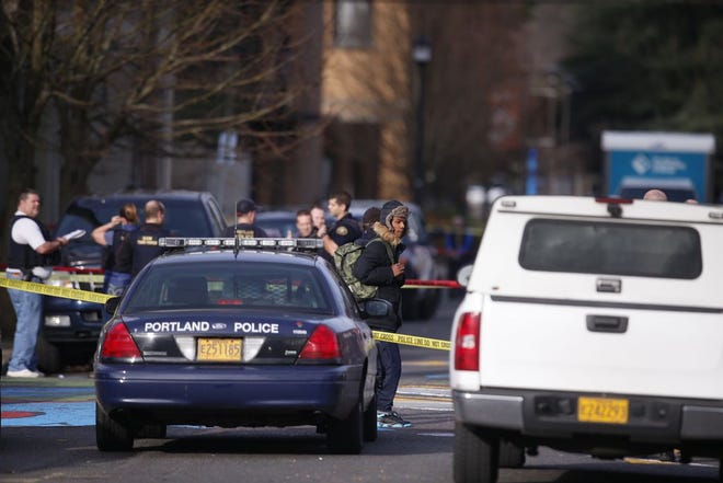 The scene in North Portland where a shooting occurred near Rosemary Anderson High School on Dec. 12, 2014. A shooter wounded two boys and a girl outside the high school Friday in what may be a gang-related attack, police said. (AP Photo/The Register-Guard, Bruce Ely)