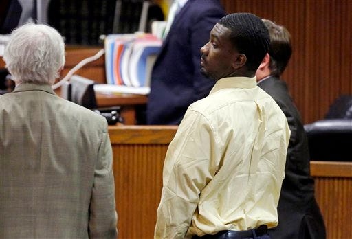 Desmonte Leonard, center, stands in the courtroom after a jury found him guilty of capital murder, Tuesday, Oct. 7, 2014, in Opelika, Ala., in the killing two former Auburn University football players and a third man. (AP Photo/Opelika-Auburn News, Todd J. Van Emst)