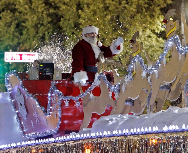 Santa Claus waves to the crowd as he arrives aduring the 39th annual West Alabama Christmas Parade along University Boulevard and Greensboro Avenue in downtown Tuscaloosa Monday, Dec. 8, 2014. Michelle Lepianka Carter | The Tuscaloosa News