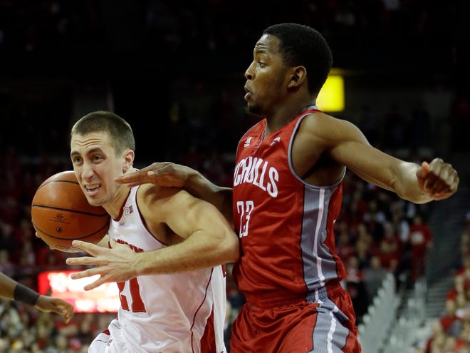 Wisconsin's Josh Gasser (21) tries to drive past Nicholls State's Quinton Thomas during the first half of an NCAA college basketball game Saturday, Dec. 13, 2014, in Madison, Wis.