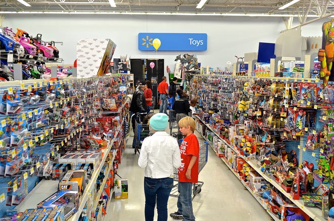 Volunteers with their young shoppers check out the toy section together Saturday, Dec. 13, 2014 during the annual Jaycees Christmas Shopping Tour at the Wal-Mark store on SW 19th Ave Road in Ocala, Fla.