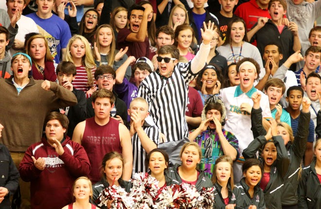 Jack Kuhn (center) jumps in celebration with the rest of the Salina Central student section after a missed free throw by the Railers’ Abby Schmidt with 5.8 seconds left in regulation. Schmidt missed both free throws, and the Mustangs held on to win 50-48.