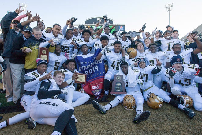The Shelby Golden Lions celebrate their 2A state championship win over Clinton in Winston-Salem on Saturday, Dec. 13, 2014. (David Grose/Special to the Star)