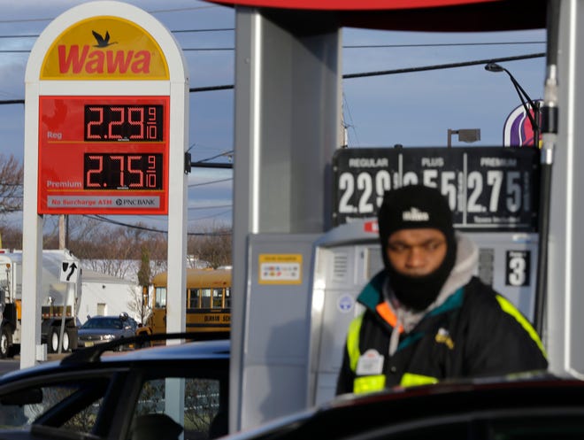 As a worker pumps gas, a sign shows that regular is $2.29-a-gallon Friday in Neptune, N.J. Motorists are now seeing prices under $3 a gallon for the first time in four years.