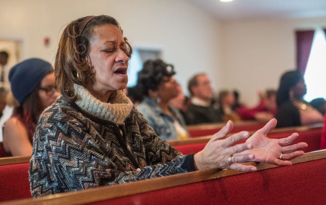 Theresa Thomas, of Bristol prayed during a service to end gun violence at the Norton Ave Baptist Church in Bristol, Pa, Sunday, December 14, 2014. Photo by Bryan Woolston / @woolstonphoto.