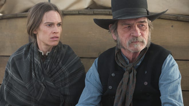 Hilary Swank and Tommy Lee Jones in “The Homesman.” In the film, Swank plays a spinster whose face reflects a rugged life on the Nebraska plains in the 1850s.