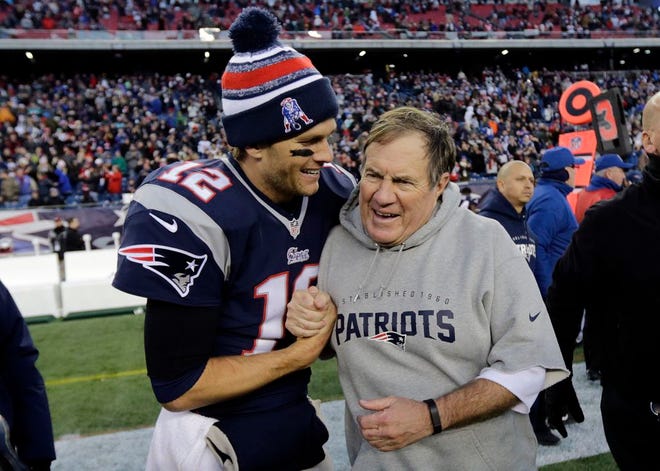 New England Patriots quarterback Tom Brady, left, celebrates with head coach Bill Belichick after defeating the Miami Dolphins 41-13 on Sunday in Foxborough, Mass.