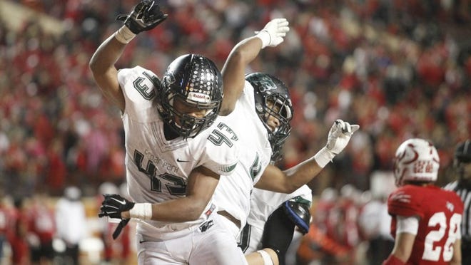 Cedar Park’s Thomas Hutchings (43) celebrates a touchdown with his twin brother, Chris, during their team’s 49-21 victory over Crosby in a Class 5A, Division II state semifinal last week. (Stephen Spillman/For American-Statesman)