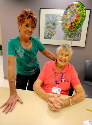 Auxiliary volunteer Karen Downey, left, stands with her 97-year-old mother Maxine Shand, also a volunteer, on Shand's birthday in the day surgery waiting room at Northwest Texas Hospital on Sept. 22, 2010.