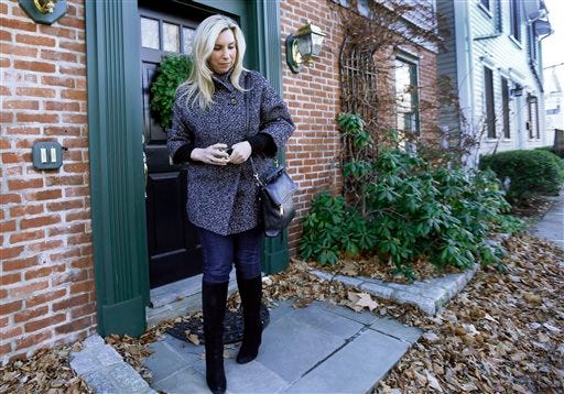 2013 Boston Marathon bombing survivor Heather Abbott walks out the door of her home in Newport, R.I., Friday, Dec. 12, 2014. For Abbott, who lost her left leg, One Fund Boston helped cover the costly prosthetics that allowed her to reclaim some degree of normalcy. Twenty months and $80 million later, the charity set up to help victims of the bombings is closing down.
