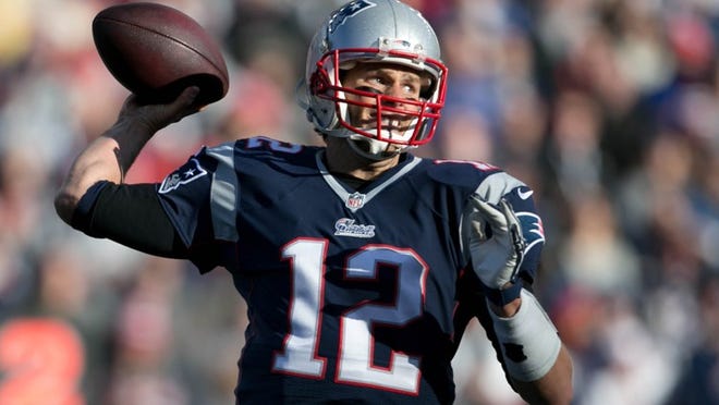 New England Patriots quarterback Tom Brady (12) back to pass against the Dolphins at Gillette Stadium in Foxborough, Massachusetts on December 14, 2014. (Allen Eyestone / The Palm Beach Post)