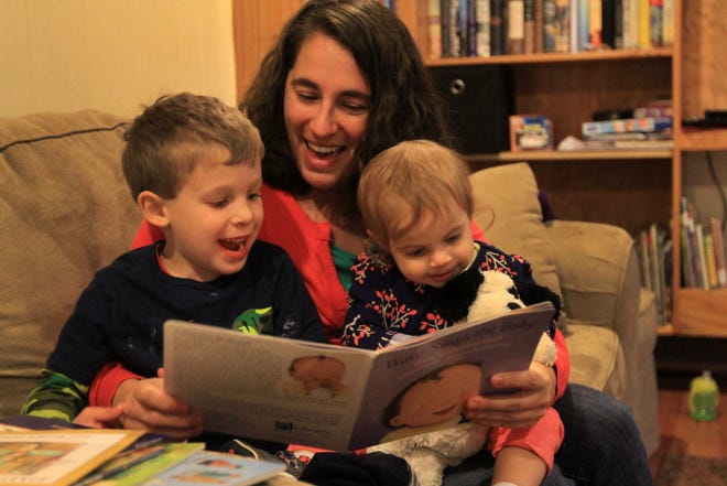 Jill Finkle reads new books with her children, Leo, left, 5, and Sally, 1. They receive free PJ Library books each month.