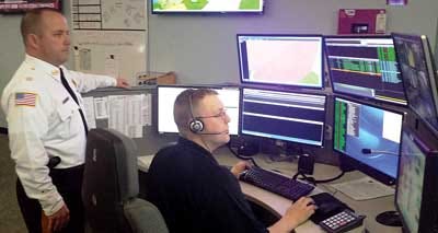 Sussex County Sheriff Mike Strada, left, stands by as 911 call center supervisor Dave Korver takes the first 911 call at the new Sussex County Sheriff’s Department Communication Center.