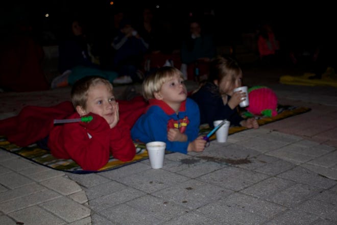 Three children enjoy the Volunteer Ascension Christmas Movie night.