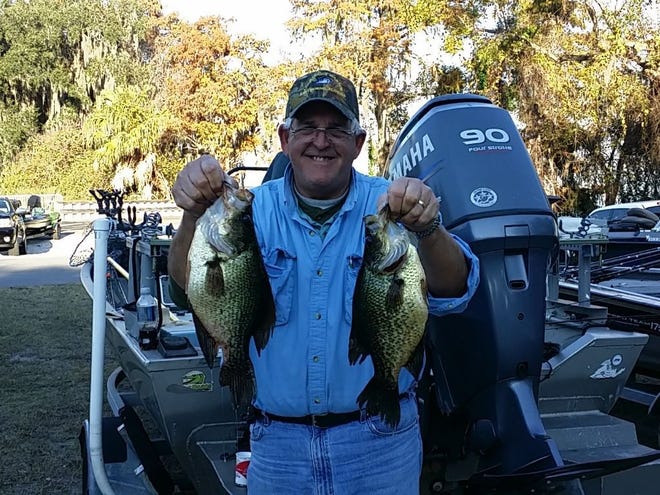 Ocala angler Danny Blankenship holds up two of the speckled perch he and teammate Greg Humphries caught during the Florida Crappie Club's Championship Classic on Lake Crescent on Saturday, Dec. 13, 2014. Blankenship and Humphries finished 10th out of 37 teams. (Submitted photo)