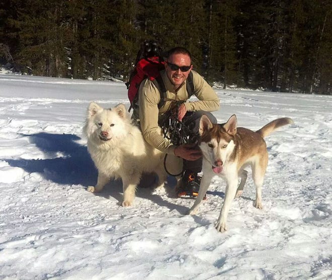 Airman Timothy Wright and his two dogs.