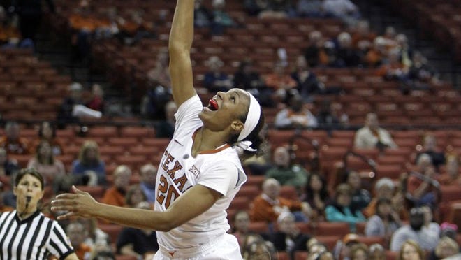 Texas guard Brianna Taylor (20) puts up a shot as she is fouled by McNeese State guard Keara Hudnall during the second half of an NCAA college basketball game, Wednesday, Dec. 17, 2014, in Austin, Texas.